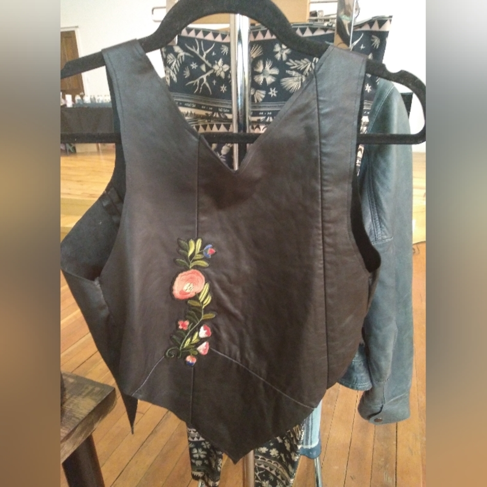 Black leather vest with flower applique patch